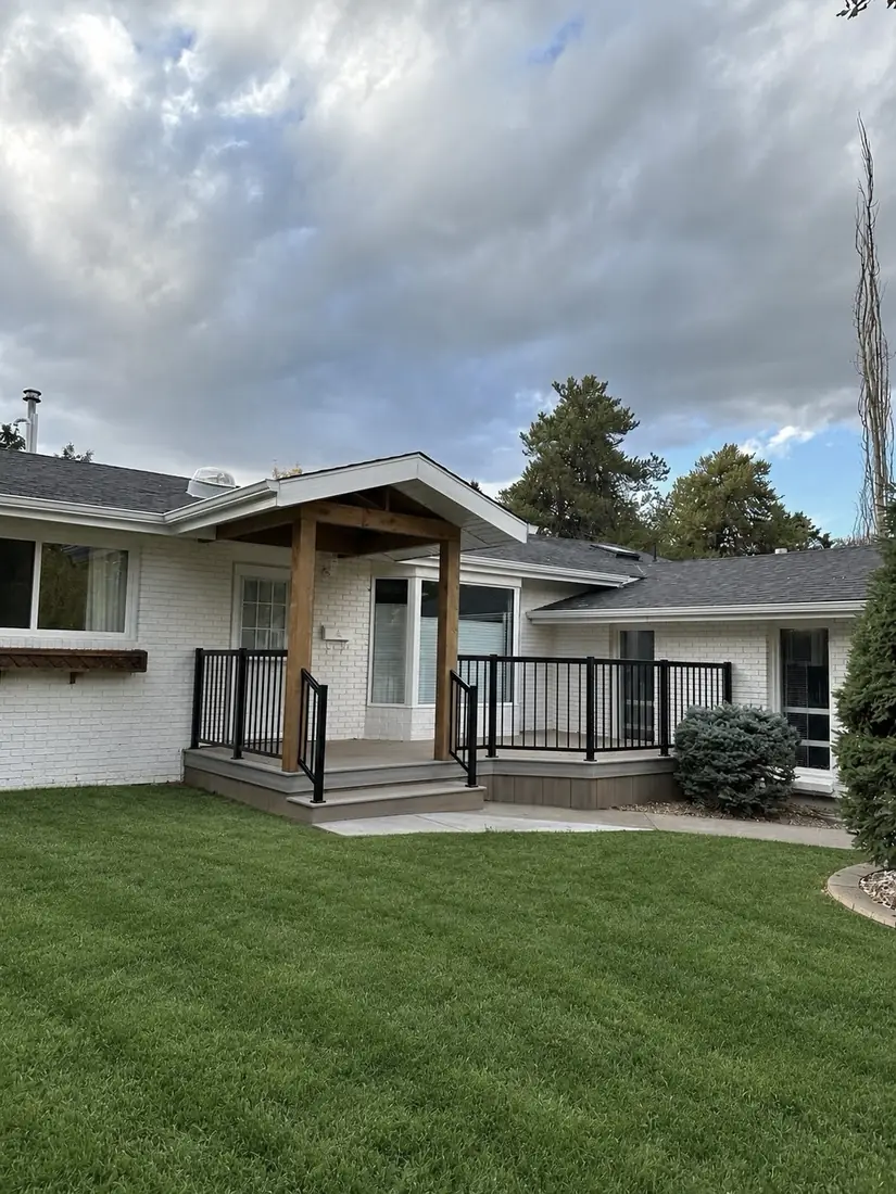Covered front entry deck with composite decking and black aluminum railing, Edmonton — TrueBlue Builders Ltd